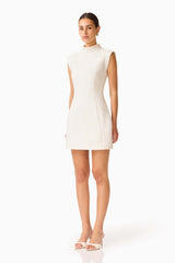 Elysia Lace Mini Dress in White with high collar neckline & tulip silhouette side shot