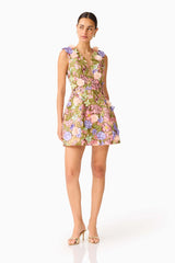Fiora Tulip Mini Dress in Green & Pink Floral with a deep neckline & 3D Floral Embroidery posed looking away shot