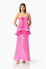 Rosera Satin Bow Maxi Dress in Pink posed shot featuring a strapless neckline and ribbon bow detail