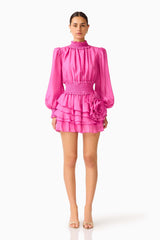 Rosera Long Sleeve Playsuit in Pink with a tiered skirt and long balloon sleeves front shot