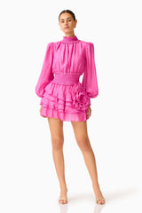Rosera Long Sleeve Playsuit in Pink with a tiered skirt and long balloon sleeves posed shot