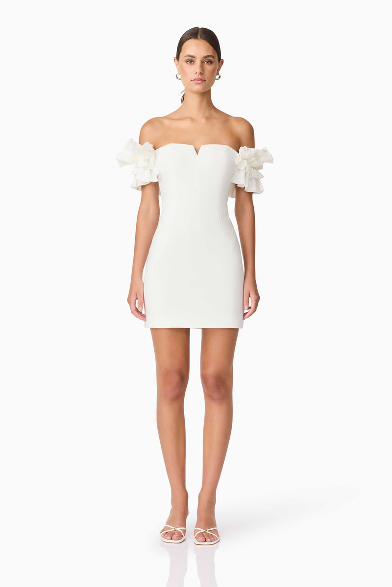 Brunette model wearing Nola Off The Shoulder Mini Dress in White front shot