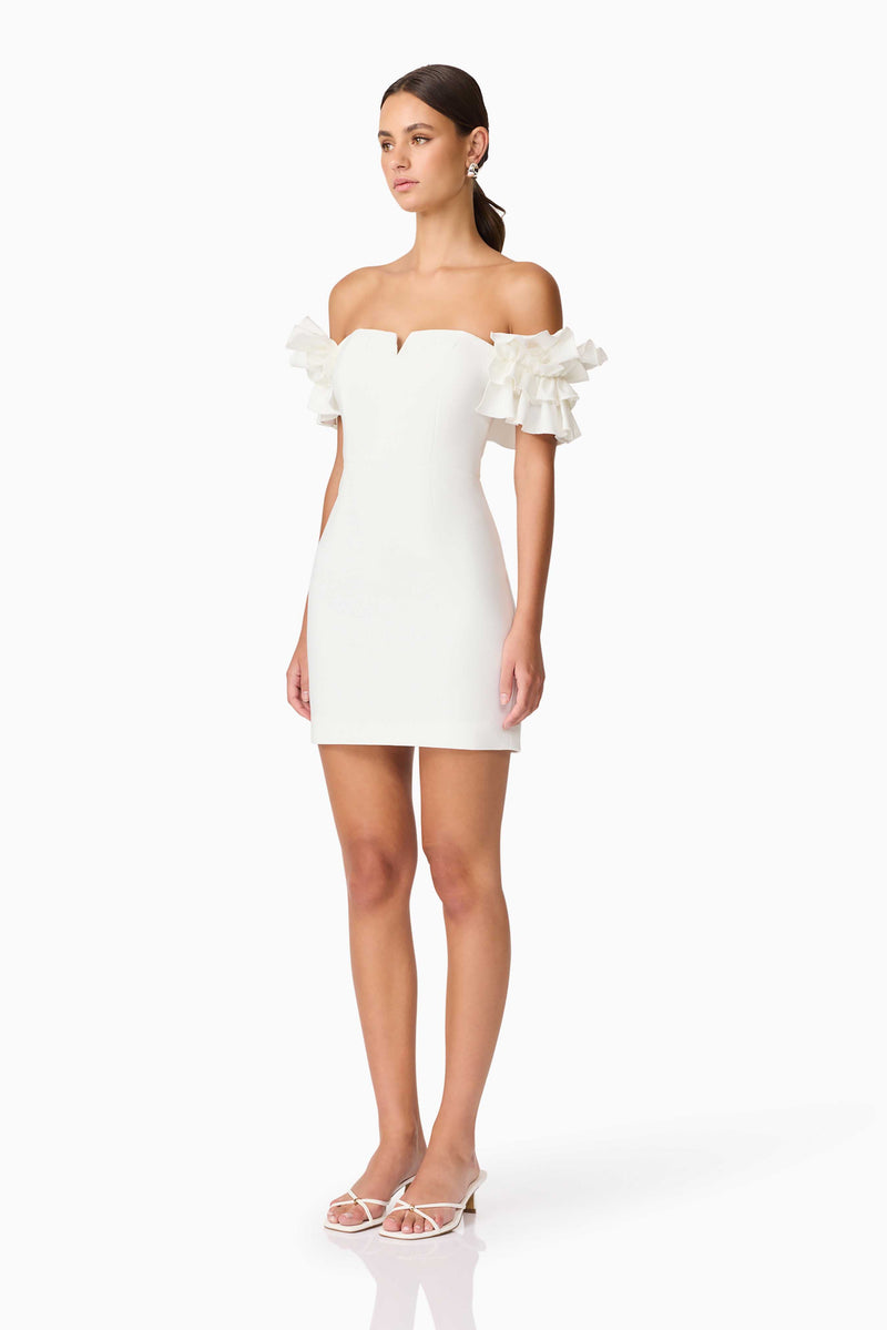 Brunette model wearing Nola Off The Shoulder Mini Dress in White side shot