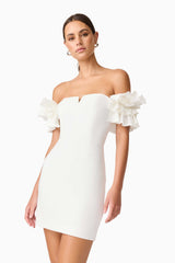 Brunette model wearing Nola Off The Shoulder Mini Dress in White close up shot