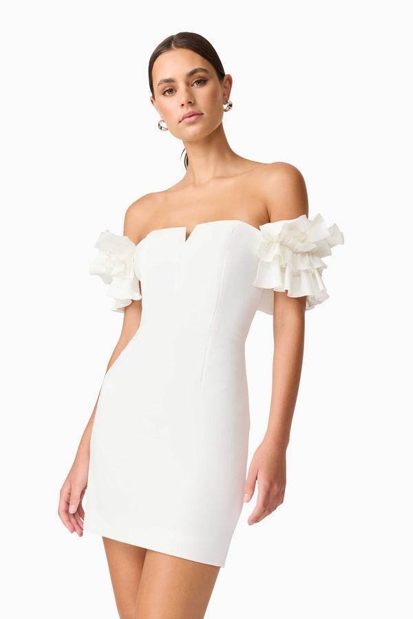 Brunette model wearing Nola Off The Shoulder Mini Dress in White close up shot