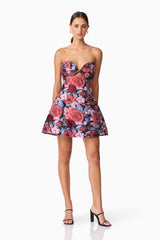 Brunette model wearing Delphine Tulip Mini Dress in Pink & Black Floral posed shot