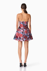 Brunette model wearing Delphine Tulip Mini Dress in Pink & Black Floral back shot