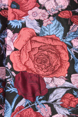 Brunette model wearing Delphine Tulip Mini Dress in Pink & Black Floral detail shot