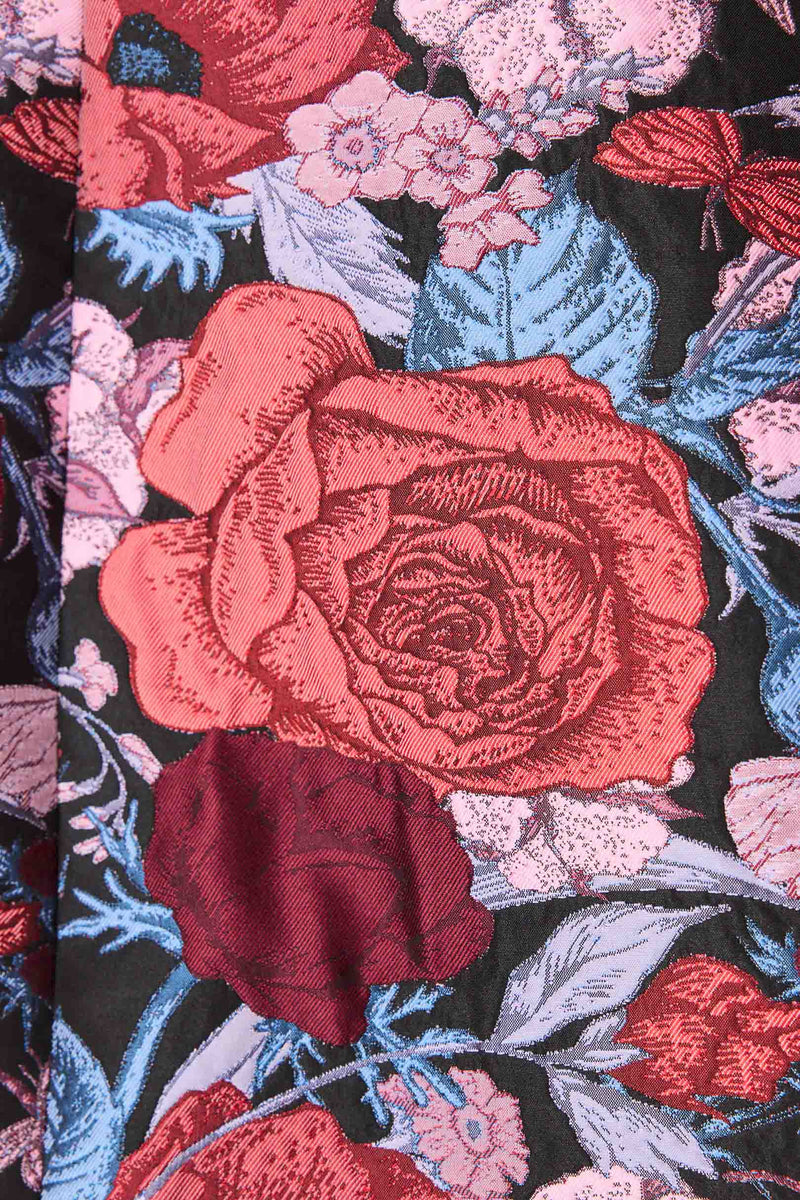 Brunette model wearing Delphine Tulip Mini Dress in Pink & Black Floral detail shot
