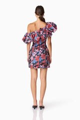 Brunette model wearing Delphine One Shoulder Mini Dress in Pink & Black Floral back shot