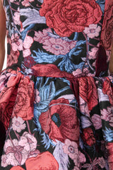 Blonde model wearing Delphine Strapless Gown in Pink & Black Floral detail shot