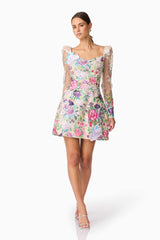 Brunette model wearing Eliska Long Sleeve Mini Dress in Floral posed shot