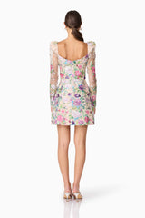 Brunette model wearing Eliska Long Sleeve Mini Dress in Floral back shot
