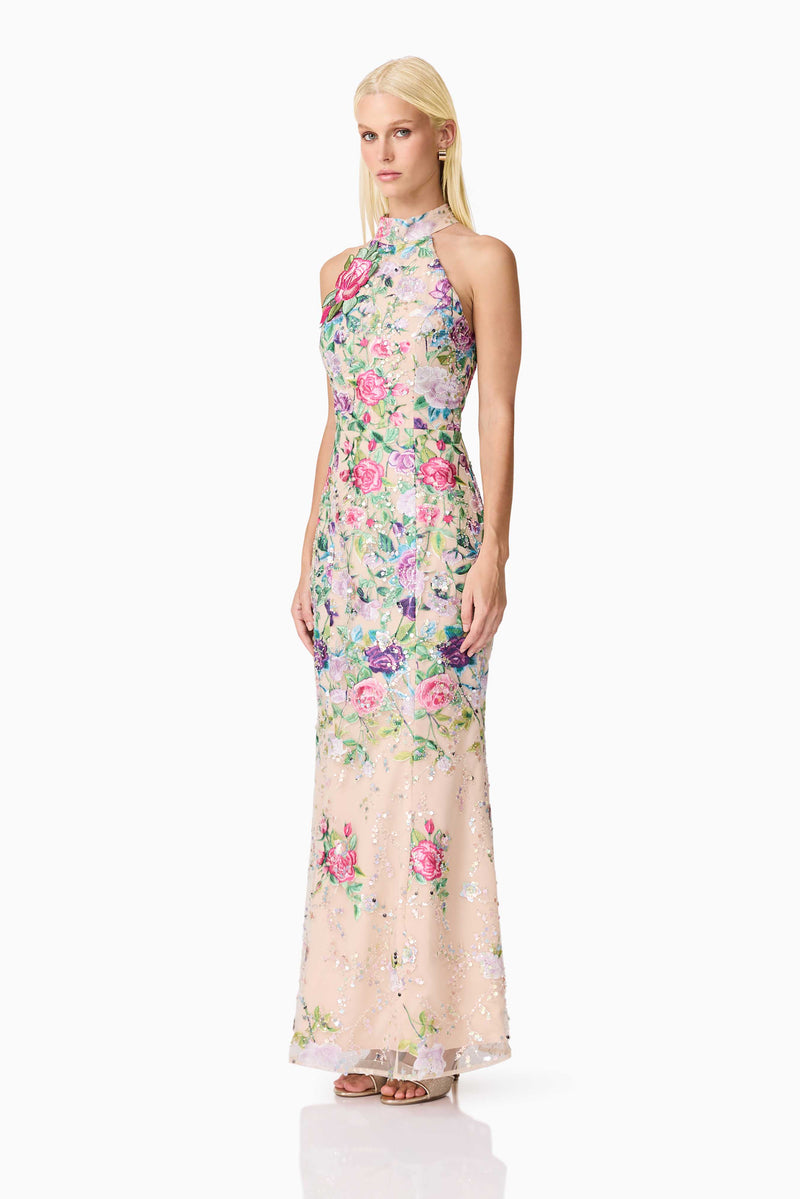 Blonde model wearing Eliska Halter Neck Gown in Floral side shot