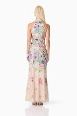 Blonde model wearing Eliska Halter Neck Gown in Floral back shot