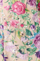 Blonde model wearing Eliska Halter Neck Gown in Floral detail shot