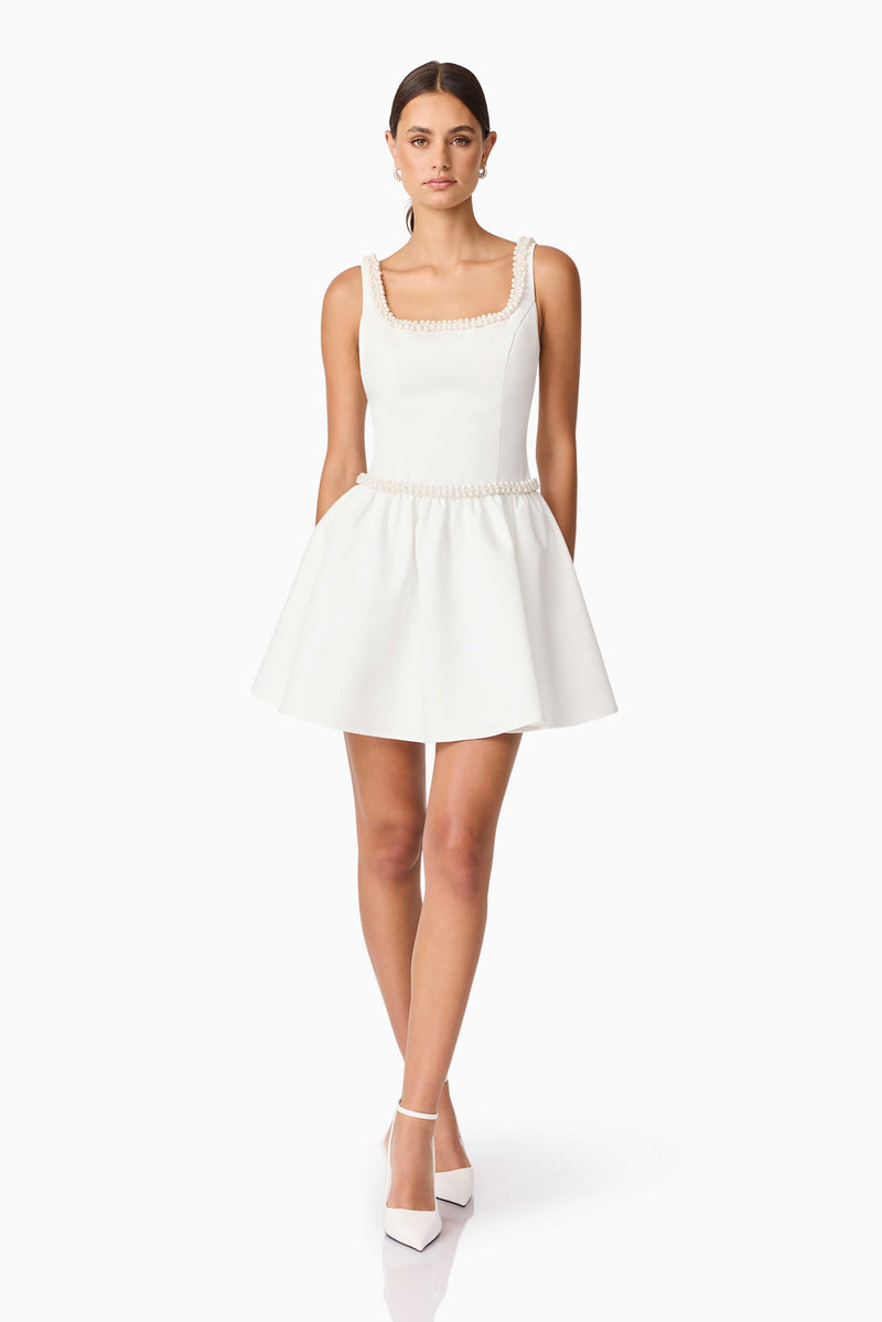 Brunette model wearing Rafaela A-Line Mini Dress in White posed shot