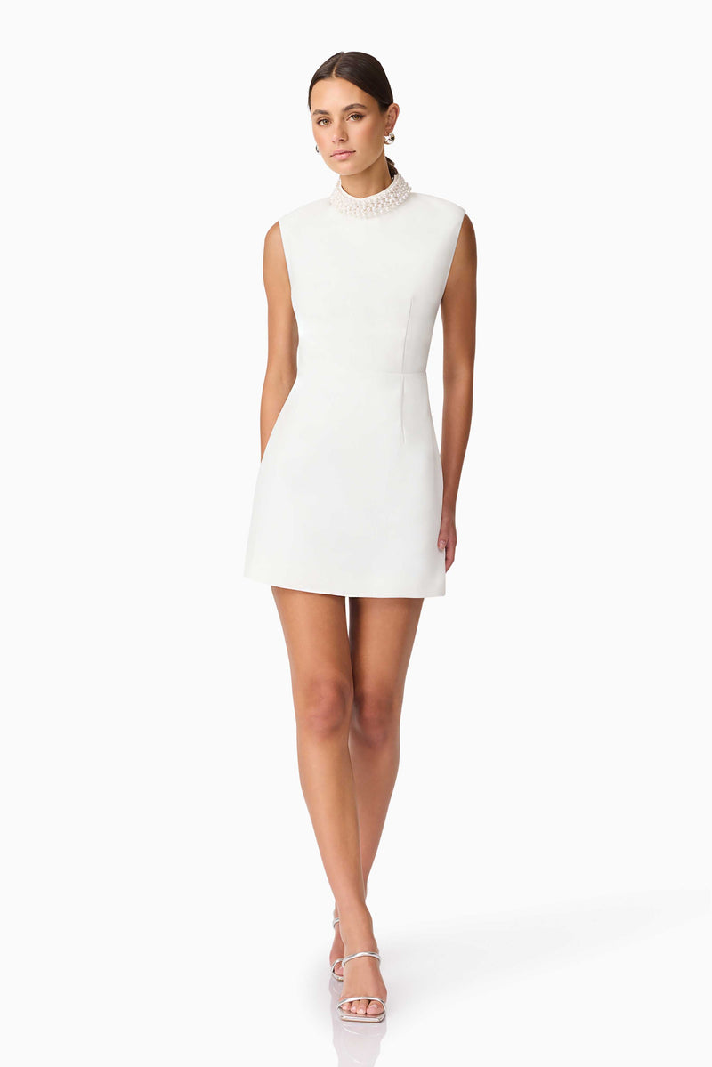 Blonde model wearing Rafaela Mini Shift Dress in White posed shot
