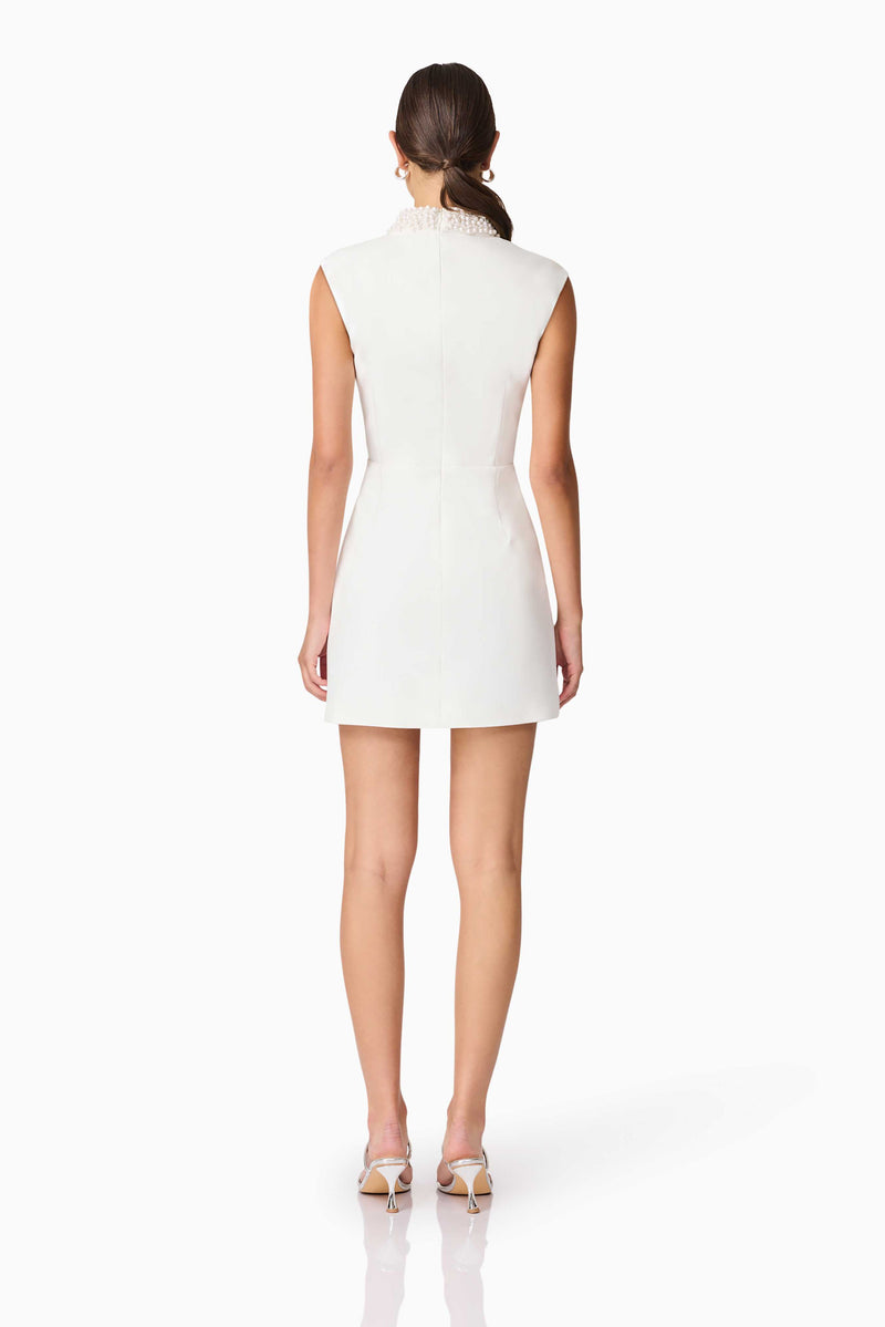 Blonde model wearing Rafaela Mini Shift Dress in White back shot