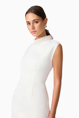 Blonde model wearing Rafaela Mini Shift Dress in White close up shot