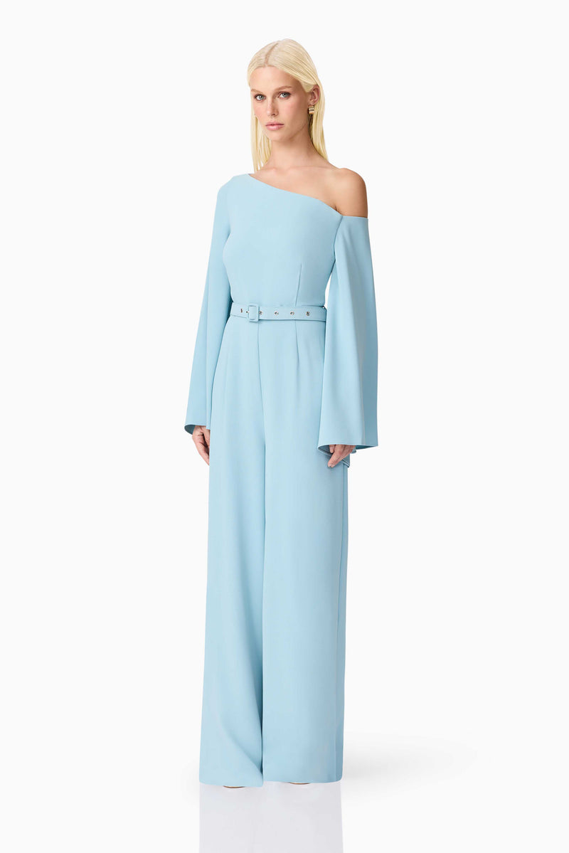Blonde model wearing Elinor Asymmetrical Jumpsuit in Blue side shot