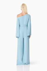 Blonde model wearing Elinor Asymmetrical Jumpsuit in Blue back shot