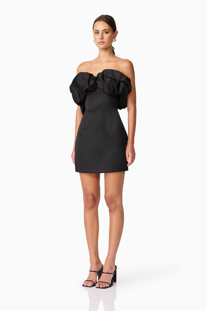 Brunette model wearing Sharon Strapless Mini Dress in Black side shot 