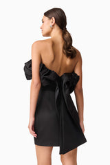 Brunette model wearing Sharon Strapless Mini Dress in Black back close up shot
