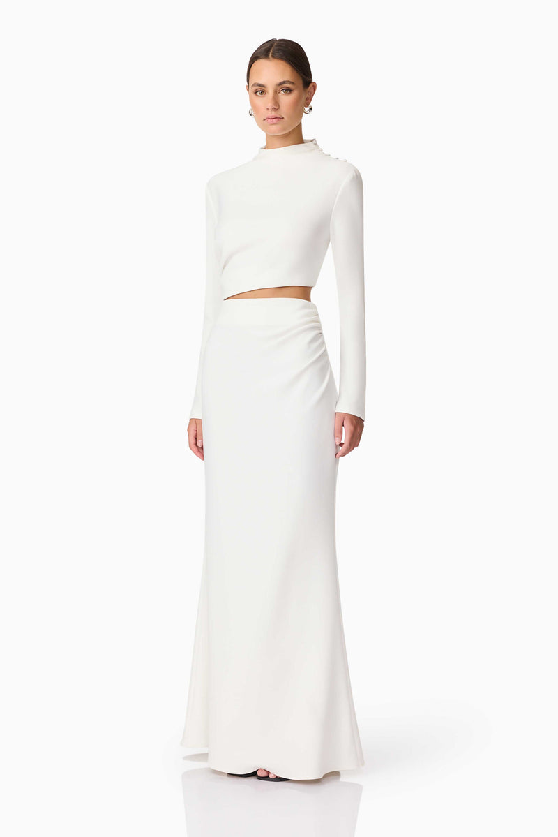 Brunette model wearing Nerissa Long Sleeve Gown in White Side Shot