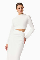 Brunette model wearing Nerissa Long Sleeve Gown in White Close Up hand on hip Shot
