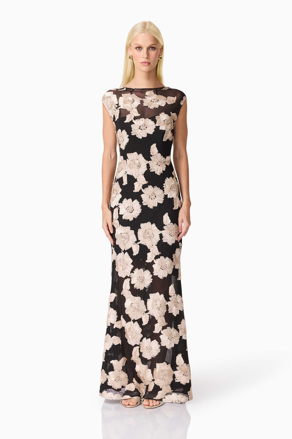 Blonde model wearing Margaus Fit & Flare Gown in Black & Gold Floral front shot