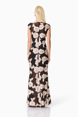 Blonde model wearing Margaus Fit & Flare Gown in Black & Gold Floral back shot
