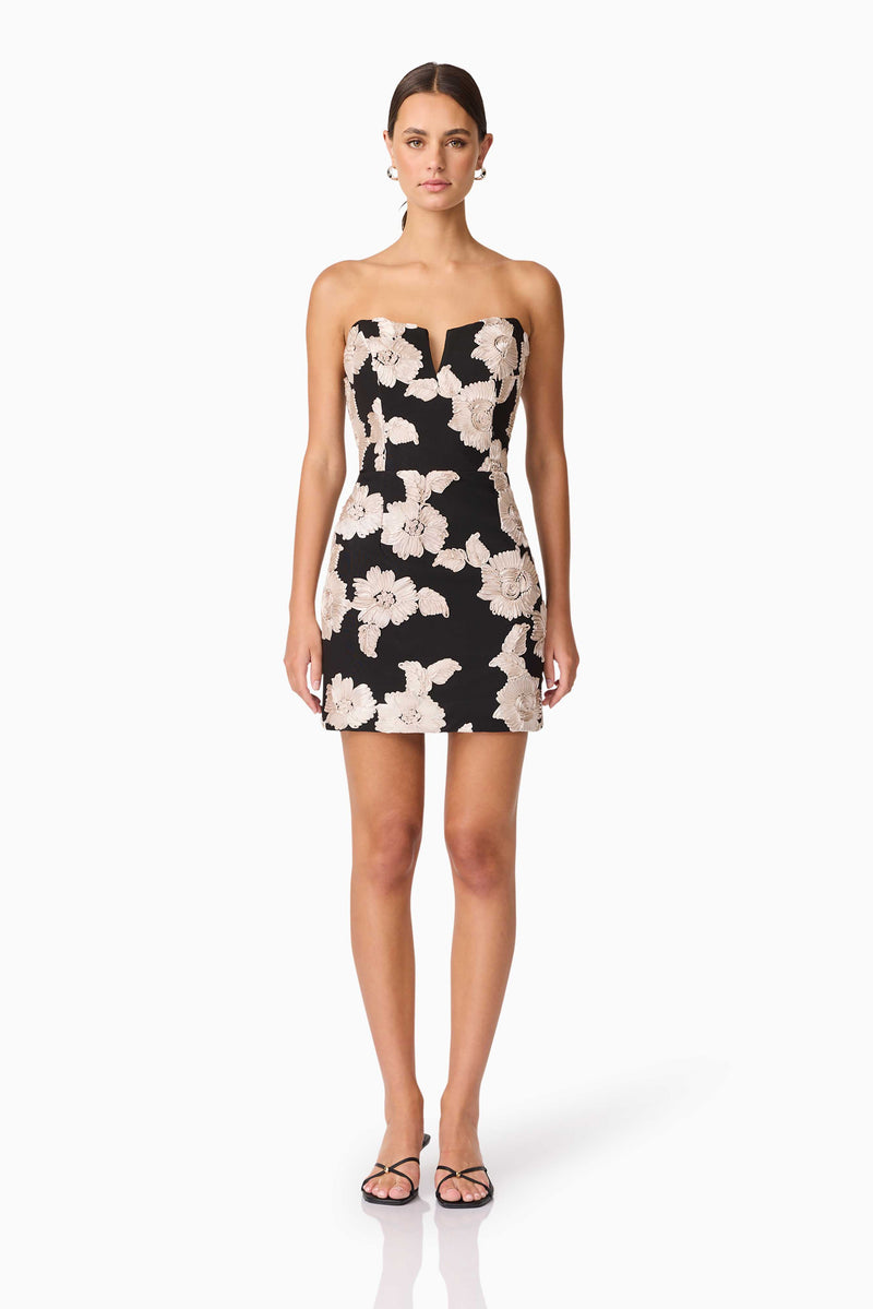 Brunette model wearing Margaux Strapless Mini Dress in Black & Gold Floral  front shot