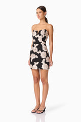 Brunette model wearing Margaux Strapless Mini Dress in Black & Gold Floral  side shot