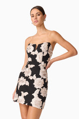Brunette model wearing Margaux Strapless Mini Dress in Black & Gold Floral  close up shot