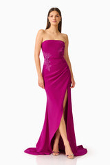 Dahlira Asymmetrical Gown in Orchid Pink with strapless neckline and slit posed shot