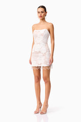 Brunette model wearing the Roxana Strapless Mini Dress in White side shot 