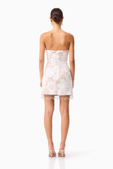 Brunette model wearing the Roxana Strapless Mini Dress in White back shot 