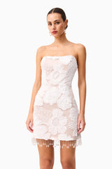 Brunette model wearing the Roxana Strapless Mini Dress in White close up shot 