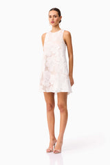 Brunette model wearing the Roxana Shift Mini Dress in White side shot