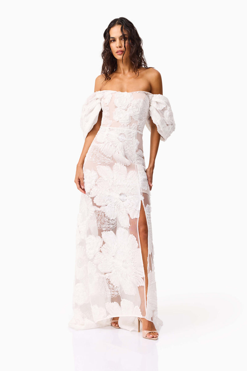 Brunette model wearing the Roxana Off The Shoulder Gown in White posed shot 