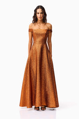 Brunette model wearing the Sapphira Off The Shoulder Gown in Orange front shot 