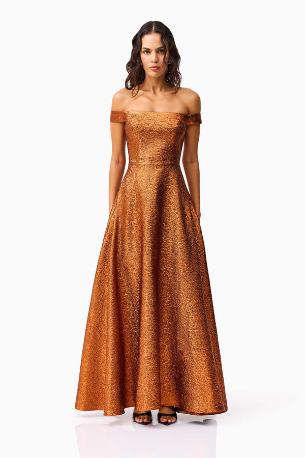 Brunette model wearing the Sapphira Off The Shoulder Gown in Orange front shot 