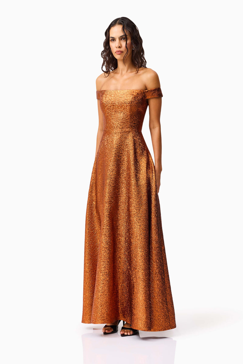 Brunette model wearing the Sapphira Off The Shoulder Gown in Orange side shot 