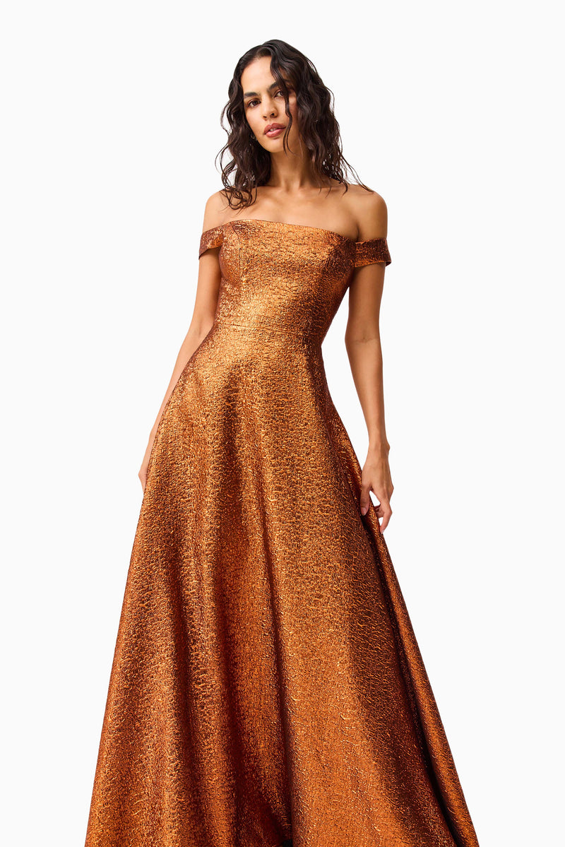 Brunette model wearing the Sapphira Off The Shoulder Gown in Orange close up shot 
