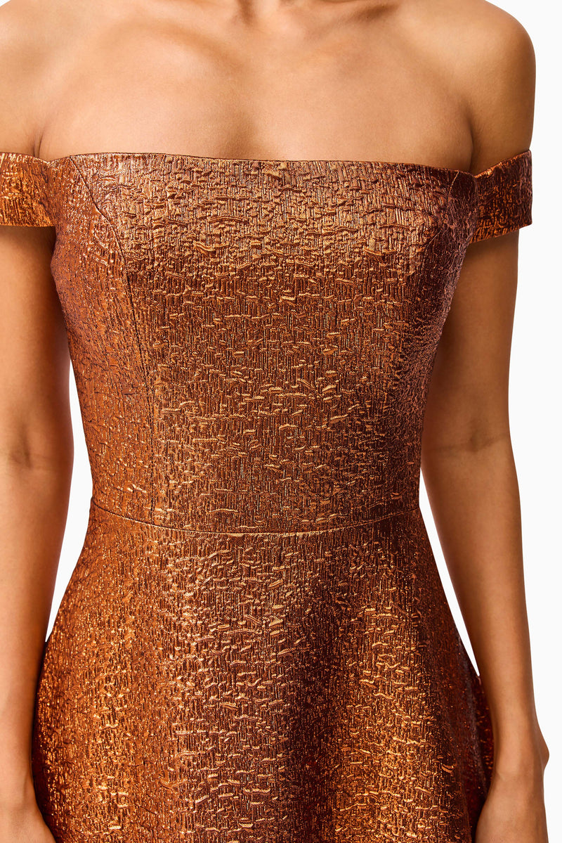 Brunette model wearing the Sapphira Off The Shoulder Gown in Orange detail shot 