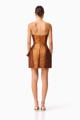 Brunette model wearing the Sapphira Strapless Mini Dress in Orange back shot