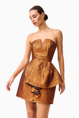 Brunette model wearing the Sapphira Strapless Mini Dress in Orange close up shot