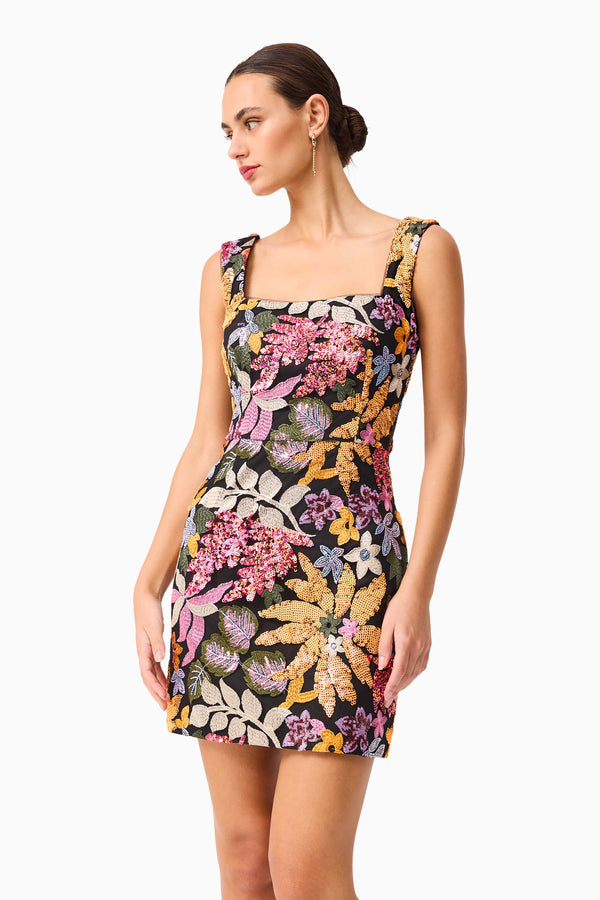 Brunette model wearing the Kiran Party Mini Dress in Orange Floral close up shot 
