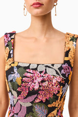 Brunette model wearing the Kiran Party Mini Dress in Orange Floral detail shot 